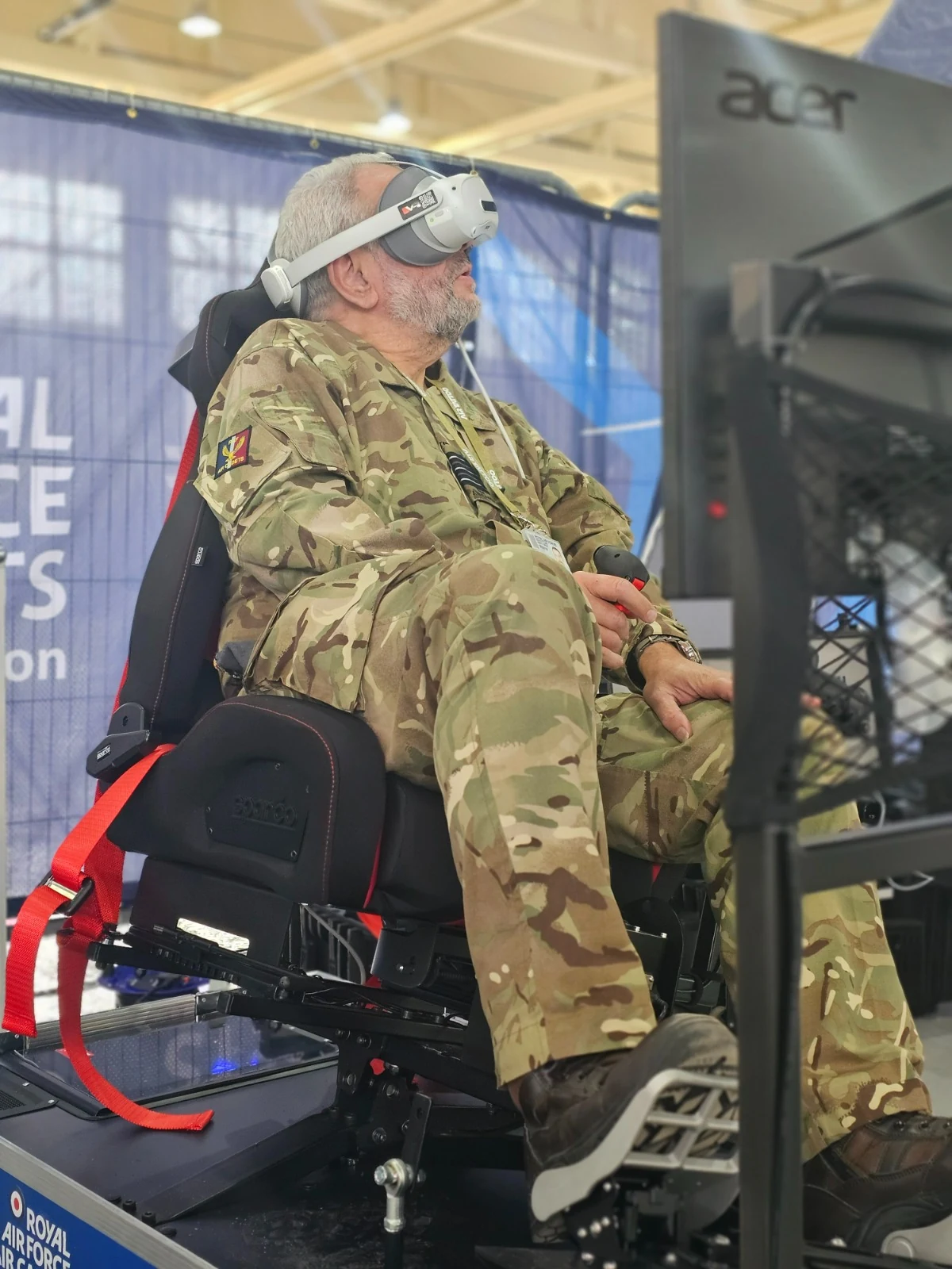 RAF personnel experiencing the All-in-One VR Motion Simulator with a virtual reality headset